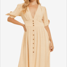 Confident woman posing in a beige buttoned midi dress with puff sleeves.