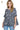 Side view of peplum blouse, showing flattering silhouette and floral pattern.