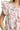 Close-up of two-tone floral print and ruffled smocked details.