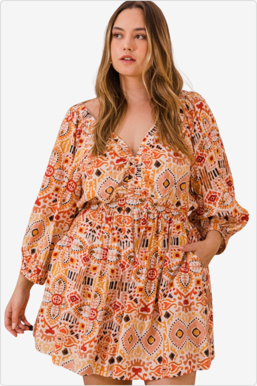 Woman in a boho-printed ruffle sleeve romper with pockets.