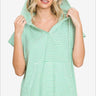Woman in a mint green and white striped short sleeve hooded top, a fresh look for casual outings.