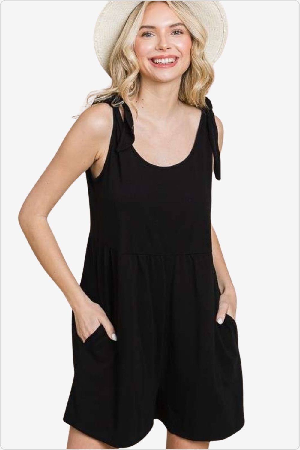 Woman in a trendy shoulder knot baggy romper, perfect for a relaxed yet stylish look, Color Black