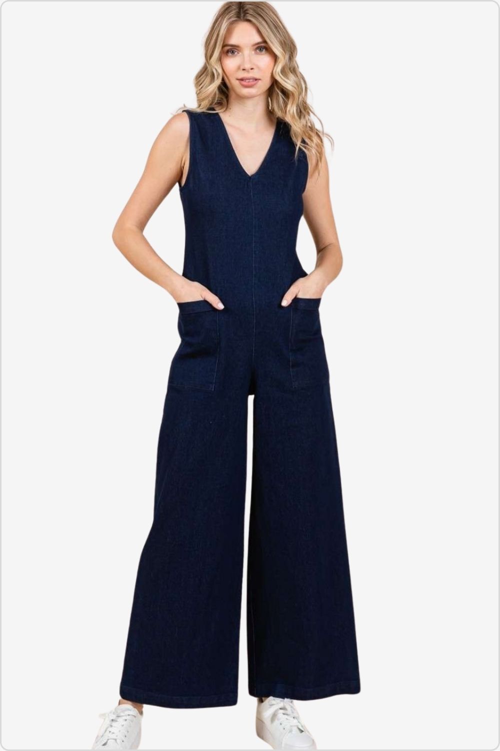 Trendy woman in a sleeveless wide leg denim jumpsuit, perfect for versatile styling, Color Dk Denim