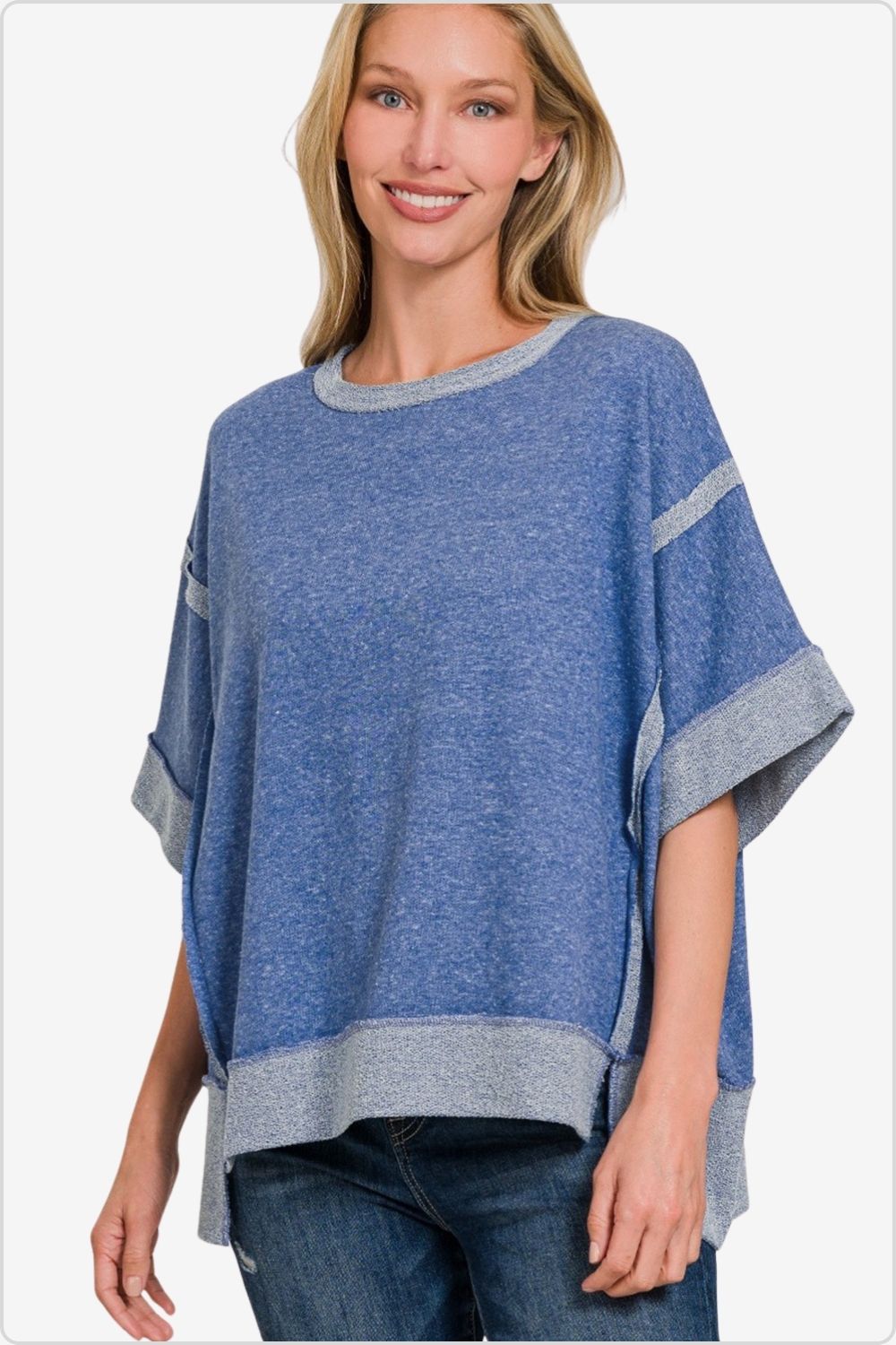 Woman in a blue drop-shoulder t-shirt with contrasting gray trim.