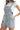 Side view of light denim romper, showing flattering fit and playful silhouette.
