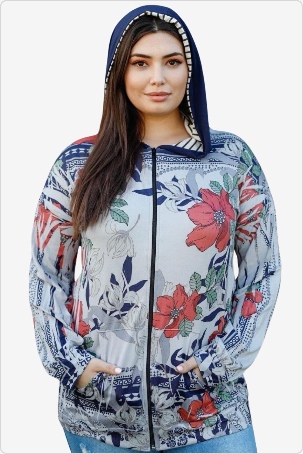 Woman in a floral print zip-up hoodie with a navy blue hood.