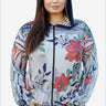 Woman in a floral print zip-up hoodie with a navy blue hood.