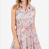 Woman in pink and blue floral sleeveless mini dress.