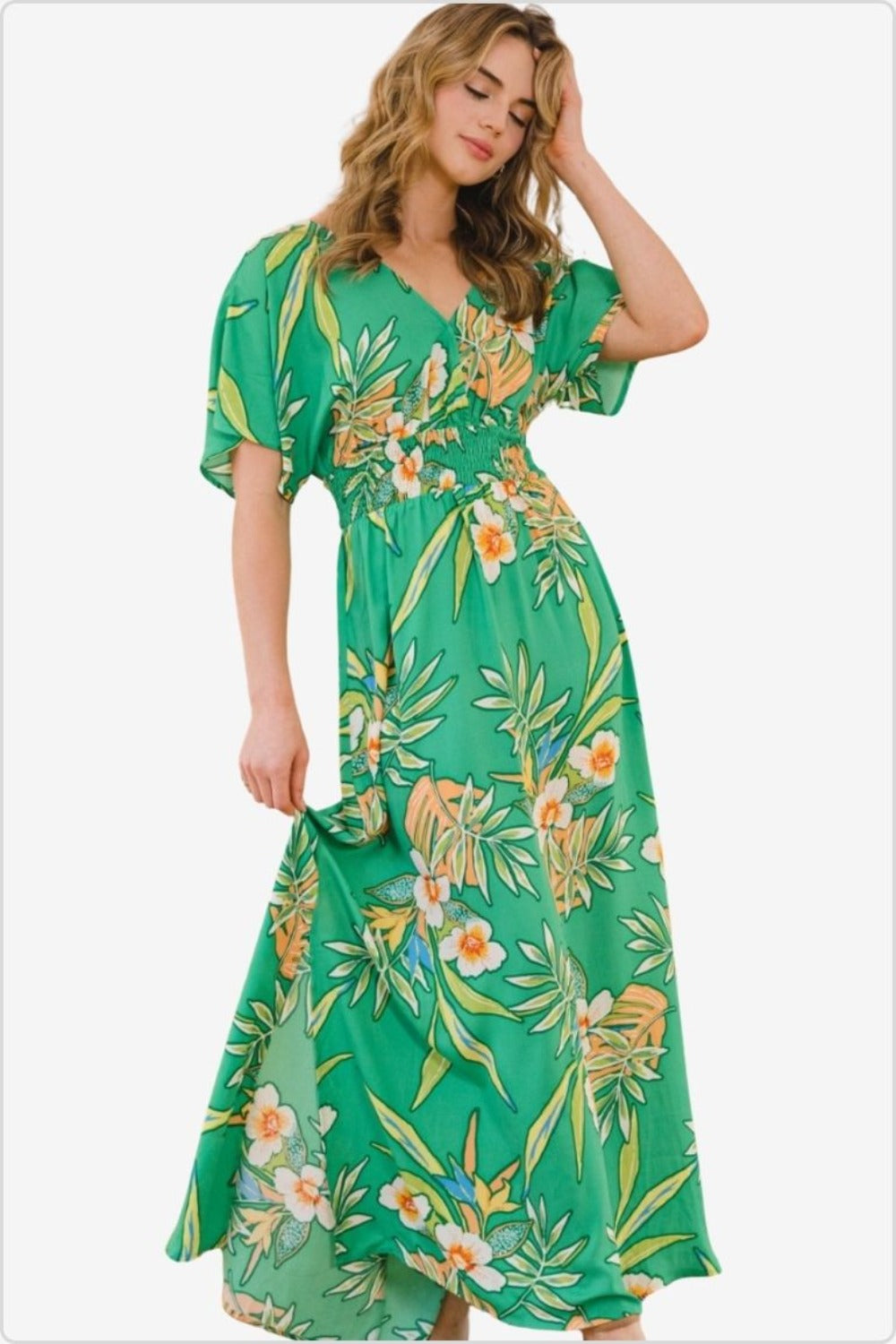 Model in a green floral smocked tie-back maxi dress with puff sleeves.