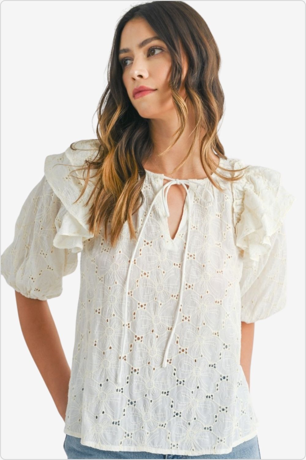 Elegant woman in eyelet lace ruffle shoulder puff sleeve blouse, perfect for sophisticated styling, Color Cream