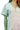 Close-up of cotton stripe knit fabric showing button neckline and texture quality