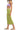 Side view of lime ribbed knit dress, showing sleek fit and dramatic cutout detail.