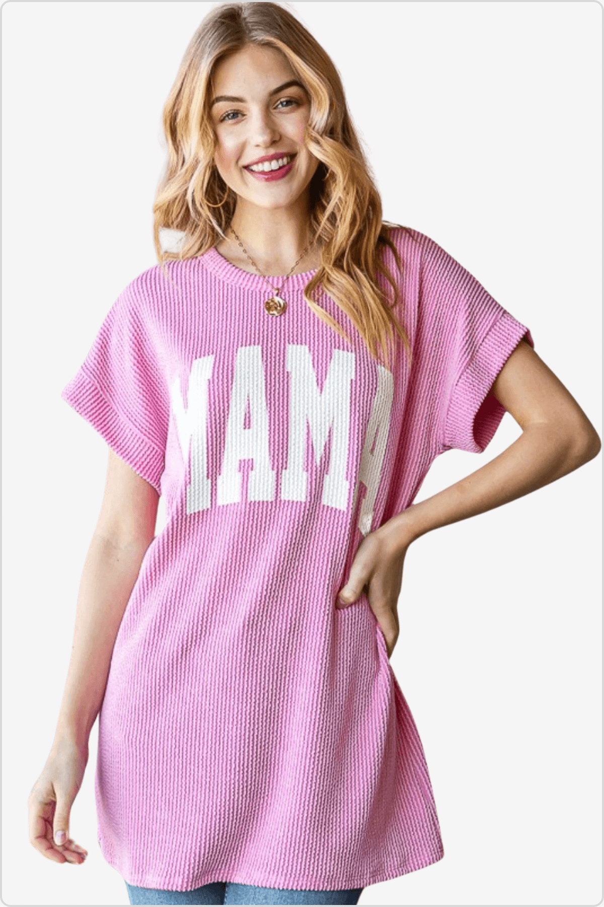 Smiling woman modeling a pink knitted t-shirt with MAMA print.