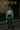 Sea foam knit styled with green vinyl skirt, chunky black boots, and silver mini bag