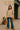 Striped tee with stars styled with flare jeans, fringe bag, and tan platform boots