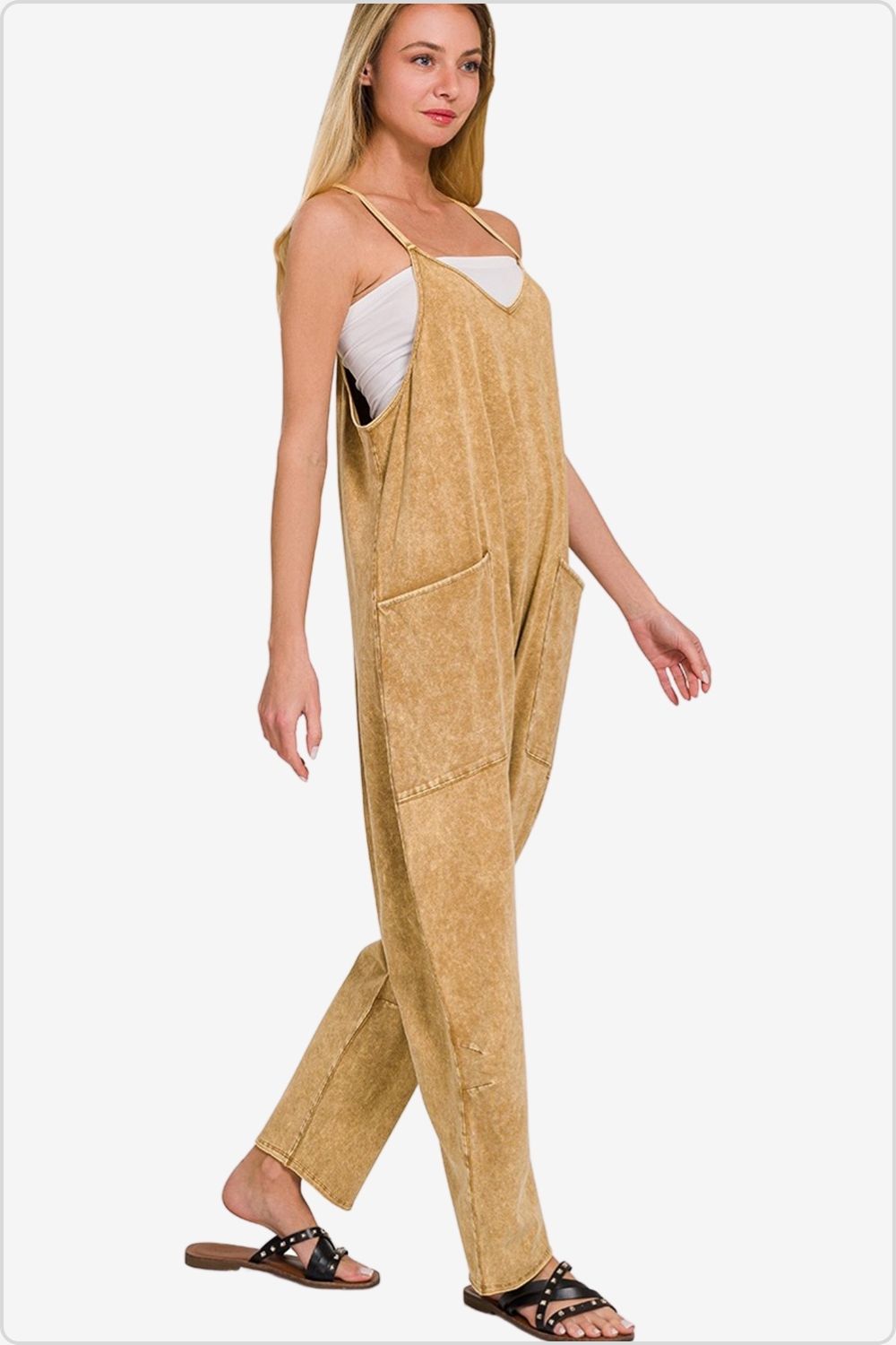 Relaxed spaghetti strap jumpsuit with pockets in a soft tan shade.