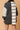 Back view of Striped Patchwork Mini Dress showing its seamless patchwork stripes and chic silhouette.