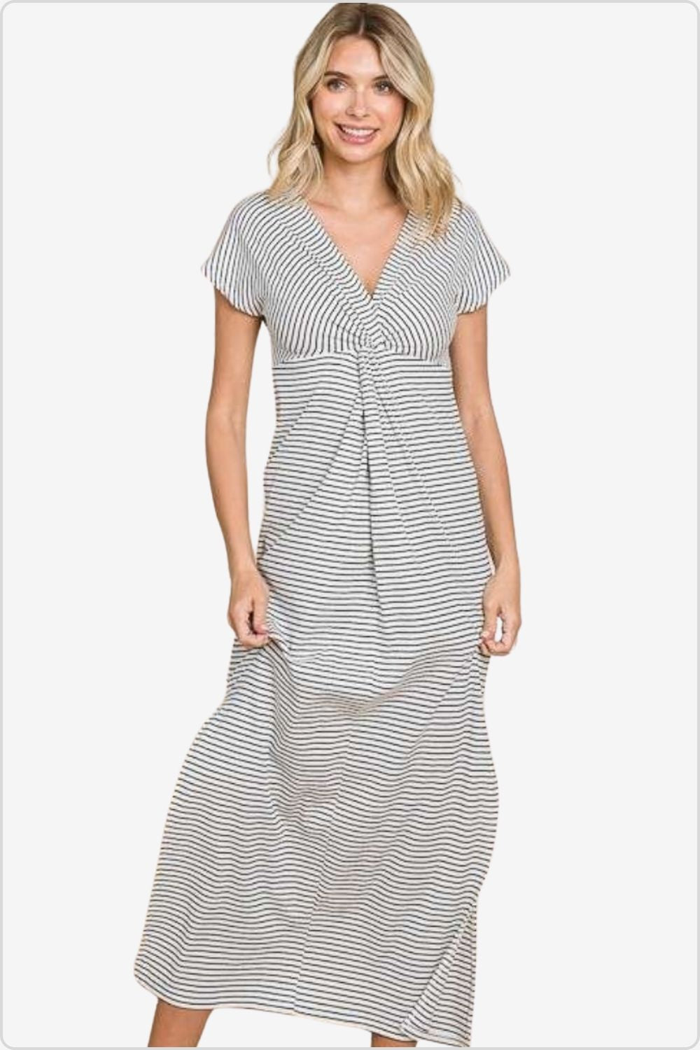 Smiling woman modeling a mid-length striped dress with twist front detail.