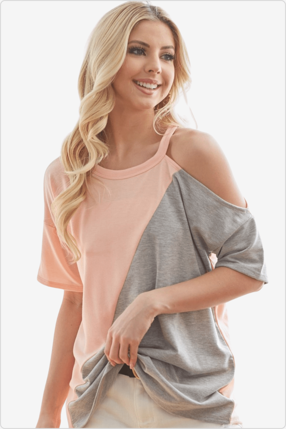 Smiling woman wearing a peach and grey color block round neck short sleeve t-shirt.