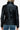 Back view of black faux leather turtleneck puffer jacket for women.