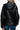 Back view of a women's black puffer jacket showcasing the hood and tailored design.