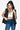 Woman wearing a black quilted hooded vest with snap and zip closure.