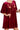 Side profile of burgundy velvet mini dress with bohemian tassel tie.
