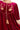 Burgundy velvet mini dress with floral embroidery and tassel details.
