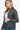 Side angle showcasing long sleeves and quilted stitching on a charcoal PU leather jacket.