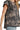 Side profile of high-low ruffled landscape print top in dark gray.