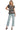 Women's ruffled landscape print top paired with straight-leg jeans.