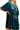 Side view of deep teal embroidered velvet dress with flowy half sleeves.
