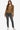 Woman in Double Zip Hooded Camel Vegan Leather Jacket, showcasing sleek lines and modern design.