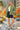 Woman wearing a green plaid button-up tweed jacket, perfect for adding a chic layer to any outfit.