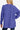 Back view of the blue high-low sweater, highlighting soft fabric and loose silhouette.