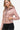 Side view of a sleek mauve women's faux leather jacket with zippered accents.