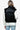 Back view of a women's black quilted vest, highlighting the quilted pattern and cozy look.
