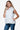 Side profile of the white vest showing the fitted design and functional pockets.