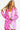 Sparkling pink sequin blazer with star pattern styled on a model showcasing a festive party-ready outfit.