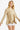 Women's taupe V-neck knit top featuring flouncy sleeves, styled with casual white shorts.