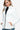 Side view showcasing the tailored fit of a white women's puffer jacket.