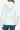 Back view of a women's white puffer jacket with a removable hood and smooth finish.