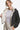Woman showing the inside of a reversible sherpa jacket, cream lining with black exterior.