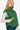 Side view of the Women's cropped puffer vest in dark green, emphasizing the sleek, sleeveless design.