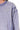 Close-up of a light purple sweatshirt with a textured pattern on a white background