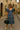 Model in blue tiered midi dress with scarf, ivory slides, black bag on Italian street