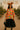 Bright balloon top styled with black tulle skirt, cowboy hat, and chain necklace