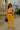 Color block blouse with mustard cargo pants, black handbag, and retro sunglasses
