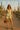 Jacquard peplum shorts set with green heels, brown bag, and scarf in cactus desert setting