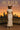 Off white sweater set styled with wide-brim hat and white platforms at golden hour